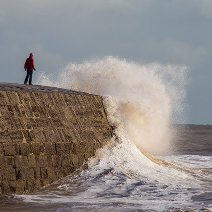 huge wave washes over The Cobb at Lyme Regis
